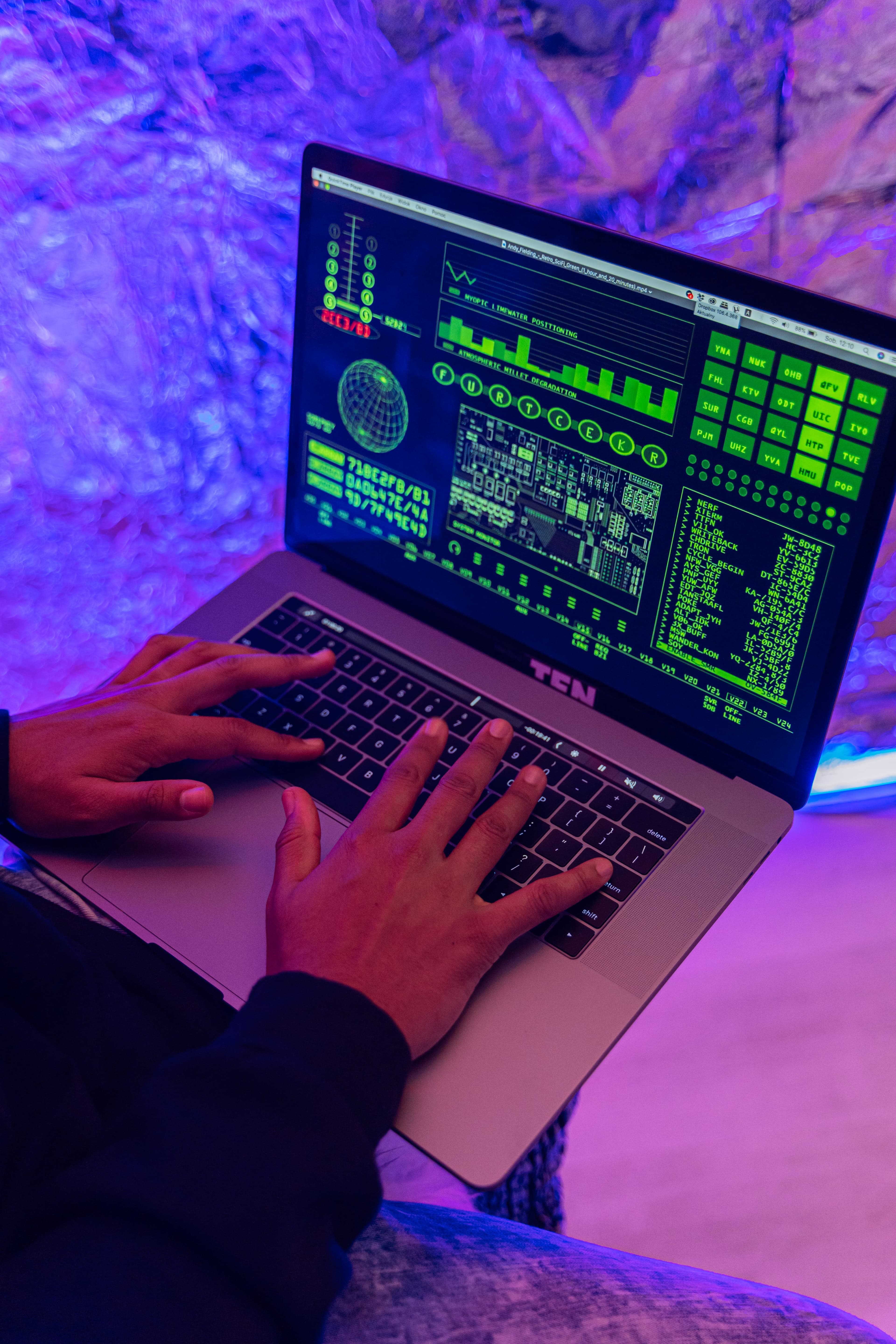 Hands typing on a laptop with a software analytics dashboard